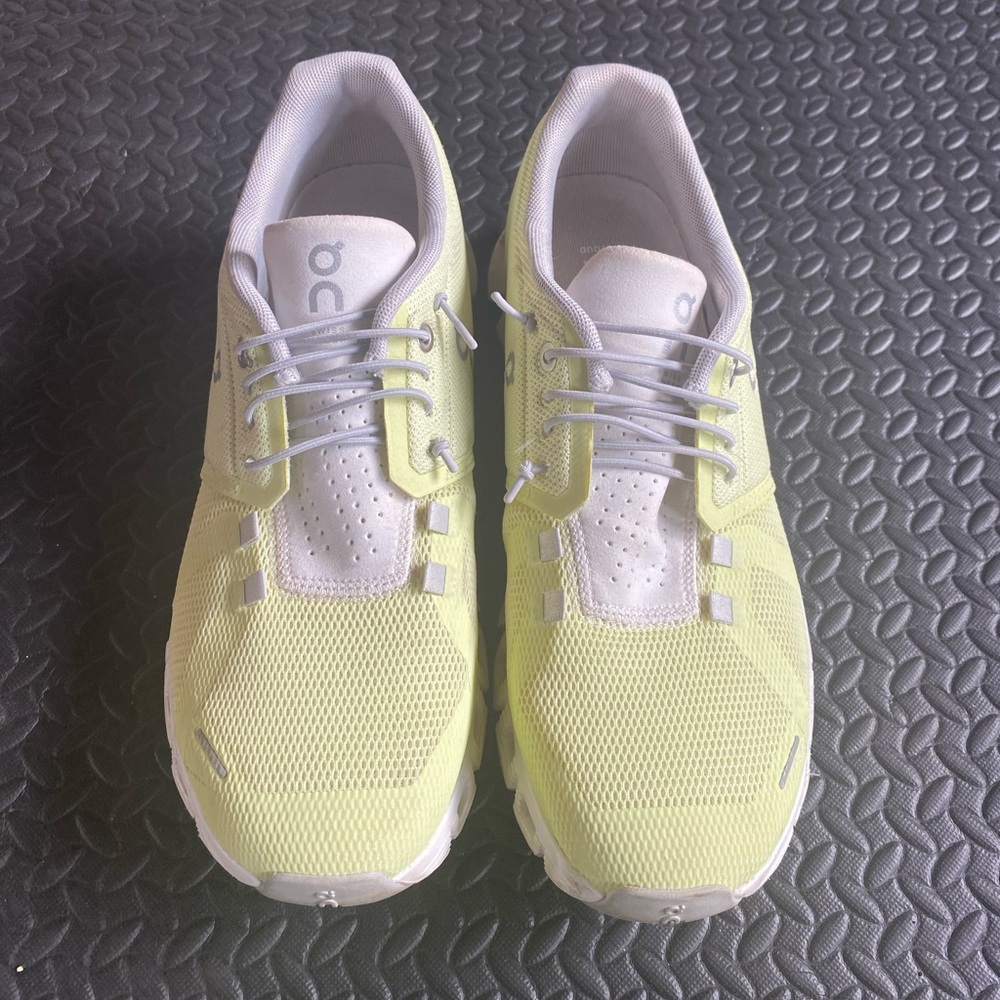 On Running Lime and Light Gray Shoes